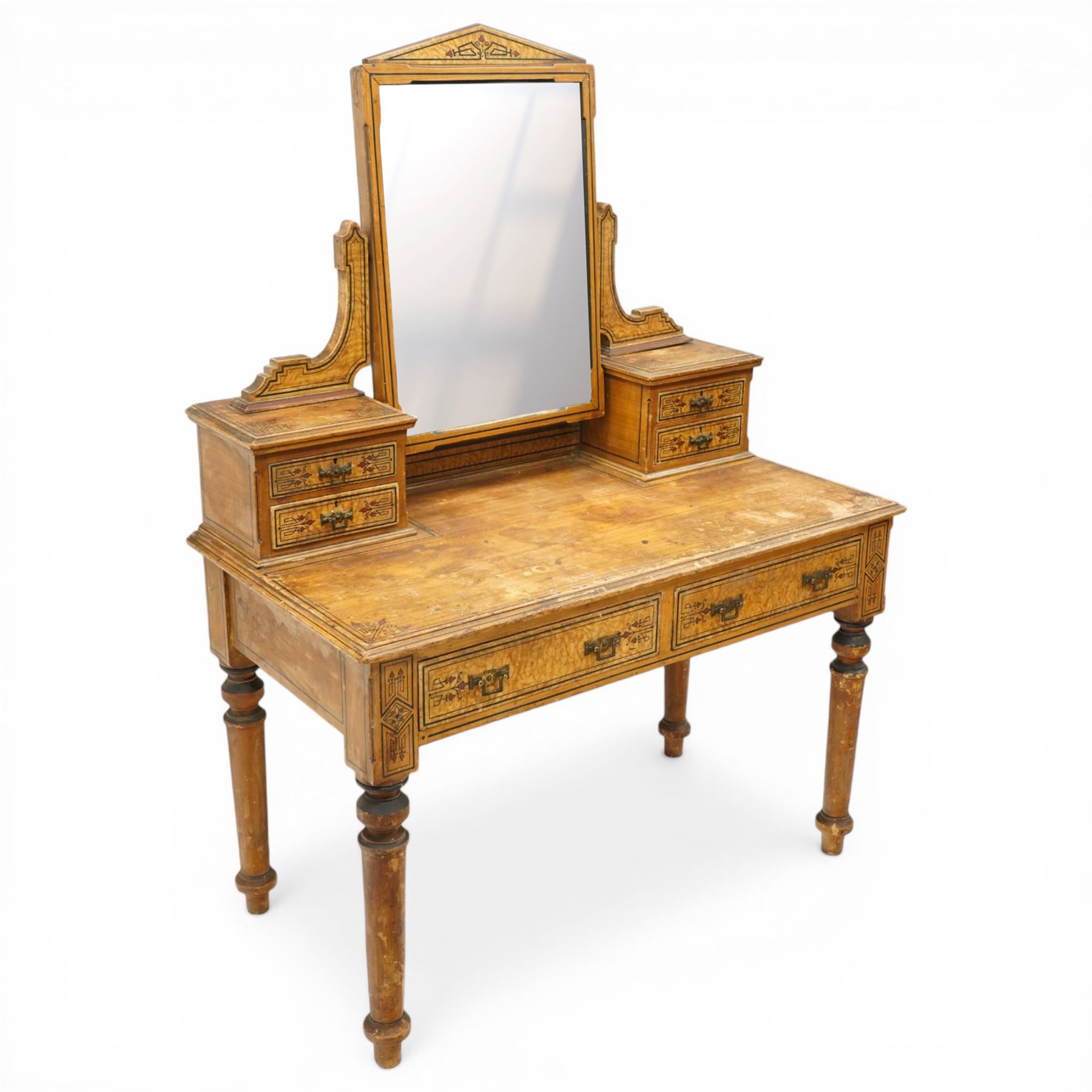 Late Victorian Aesthetic Movement scumbled and painted pine dressing table, arched swing mirror over four small trinket drawers, decorated with painted ebonised stringing and Aesthetic Movement motifs, rectangular top fitted with two drawers, on turned supports