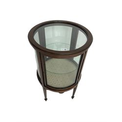 Edwardian inlaid mahogany drum shaped vitrine or bijouterie table, with glass top and sides and single door with central glass shelf, on four tapering square supports with spade feet