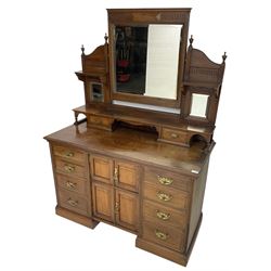 Edwardian mahogany dressing chest, raised triple mirror back with bevelled plates and fluted decoration over two trinket drawers, the base fitted with two central cupboards flanked by four graduating drawers to each side
