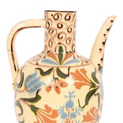Iznik-style ewer, late 19th/early 20th century, the ovoid body painted with stylized flowers upon a cream ground, the neck with repeating scrolling boarder, H28cm