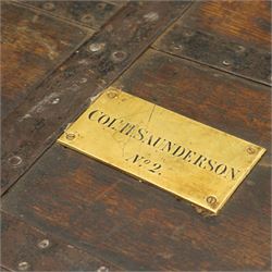 Early 19th century oak and wrought metal bound plate chest, the hinged lid with an engraved brass plaque inscribed Col H Saunderson No.2, enclosing a vacant interior, with metal carrying handles to the sides and pivoting clasp