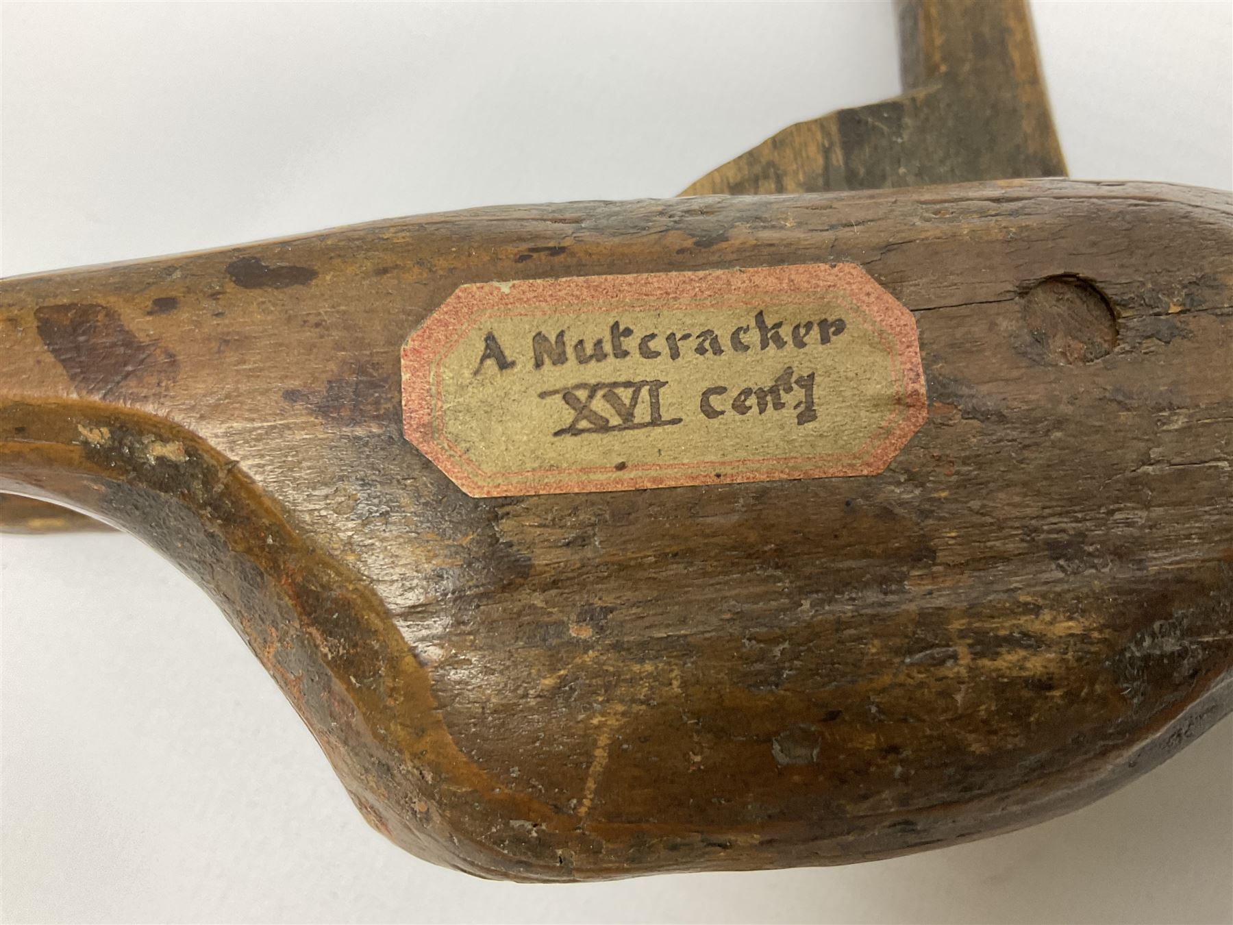 Rare primitive treen lever action nutcracker, probably late 17th/early 18th century, carved in the form of a man, with old collector label to side inscribed 'A Nutcracker XVI Century', H18cm