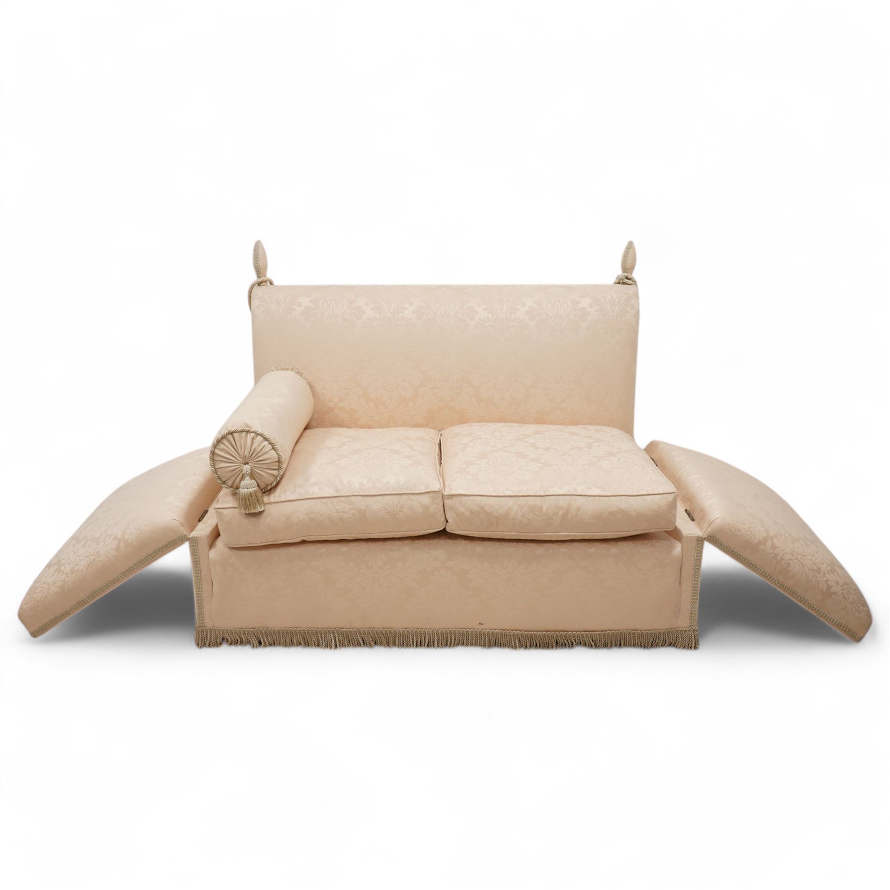 Knole design hardwood-framed drop-arm two-seat sofa, upholstered in cream Damask fabric decorated with repeating foliate pattern, with twist fringe, 