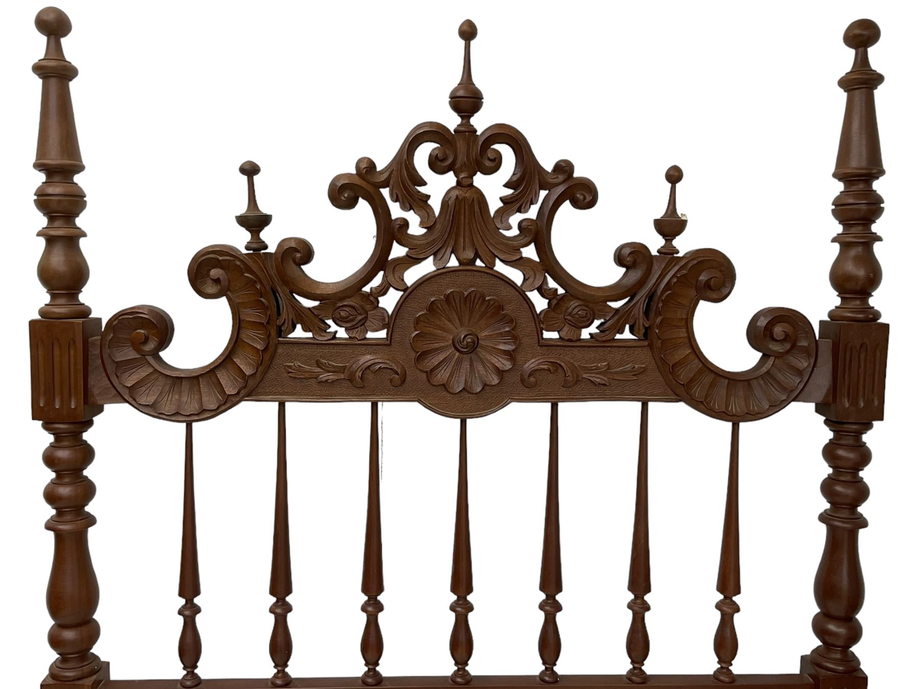 Pair of Spanish carved hardwood headboards, the pediment carved and pierced with shell C-scrolls and carved foliage, turned spindle back, on turned supports 