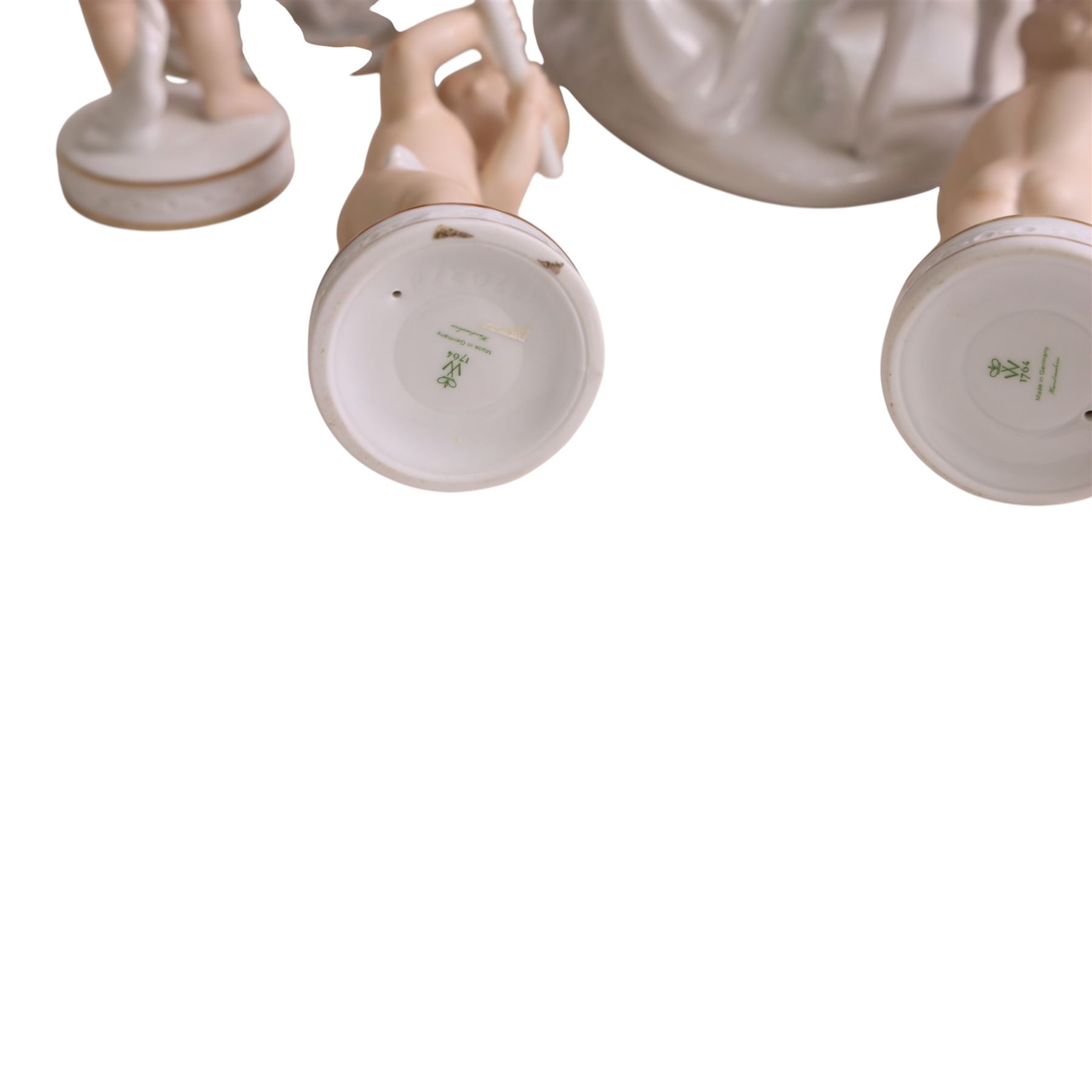 Seven Wallendorf figures, including Young woman with deer 1754, four putti with musical instruments and two cherubs, H18cm