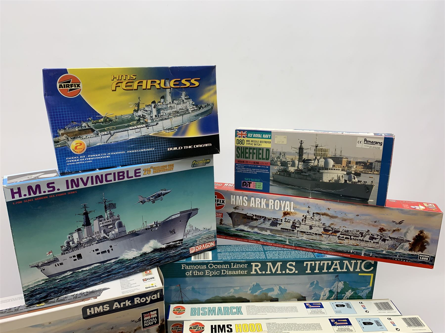 Ten plastic model kits of ships by Airfix, Revell, Dragon and Skywave, predominantly 1/600th scale including R.M.S. Titanic, HMS Invincible, two x HMS Ark Royal, HMS Fearless, HMS Hood, HMS Belfast, Bismarck etc; all boxed, most in factory sealed transparent packaging (10)
