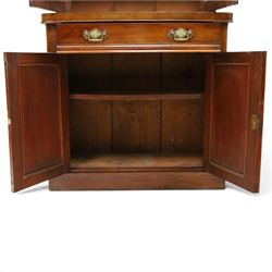 Victorian mahogany bookcase on cupboard of slender proportions, projecting cornice over dentil-frieze, fitted with twin-glazed doors enclosing three shelves, flanked by acanthus corbels, the base fitted with single frieze drawer over panelled cupboard, on skirted base