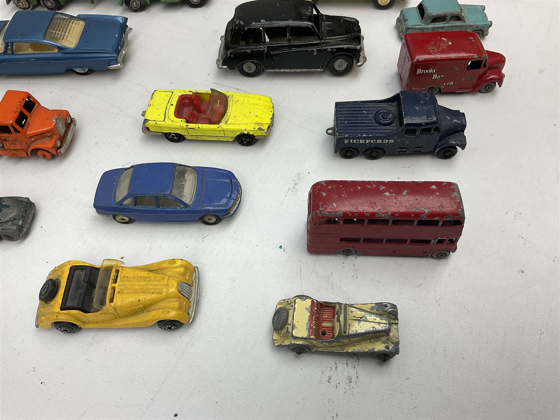 Budgie - five unboxed and playworn die-cast commercial vehicles comprising Scammell Scarab with BR Semi-Trailer, Volkswagen Pick-Up, Towing Tender & Breakdown Truck, Highwayman Transporter No.326 and Routeman Pneumajector No.322; Morestone G&E Wood open lorry and Petrol Tanker; nine early Lesney models; and small quantity of others by various makers