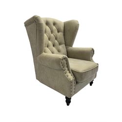 Georgian style wingback armchair, upholstered in buttoned champagne fabric with stud work, turned front feet