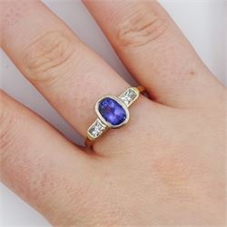 18ct gold three stone oval cut tanzanite and radiant cut diamond ring, hallmarked, tanzanite approx 1.10 carat, total diamond weight approx 0.40 carat
