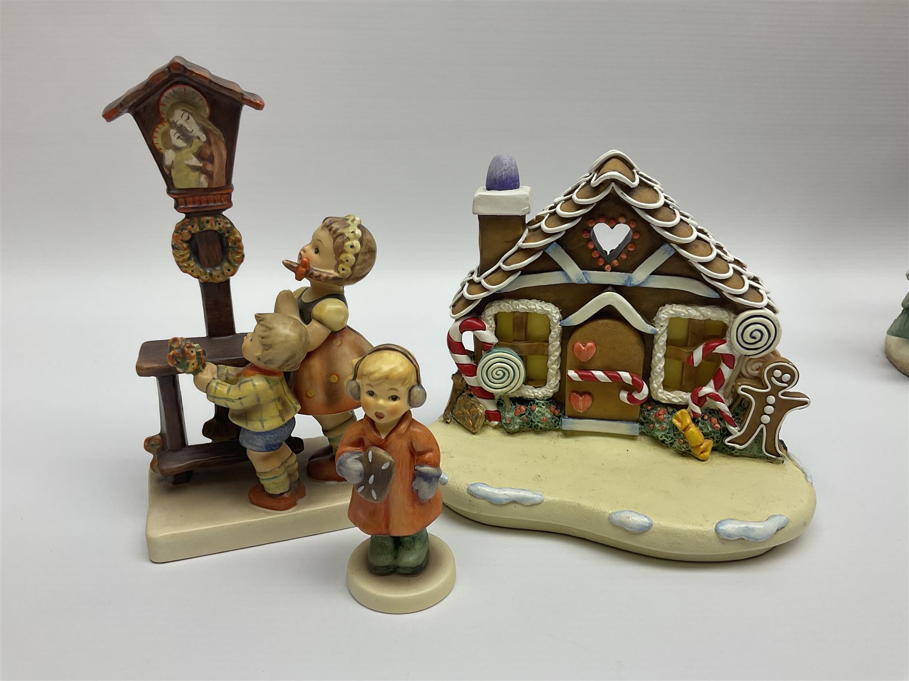 Eight Christmas Hummel figures by Goebel, to include Wintertime Chapel candle holder, Winter Fun, Christmas Morning, Christmas Time and Gingerbread Lane, tallest H21cm
