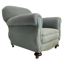 20th century traditional shape armchair, curved back and rolled arms, upholstered in light blue patterned fabric, on turned front feet