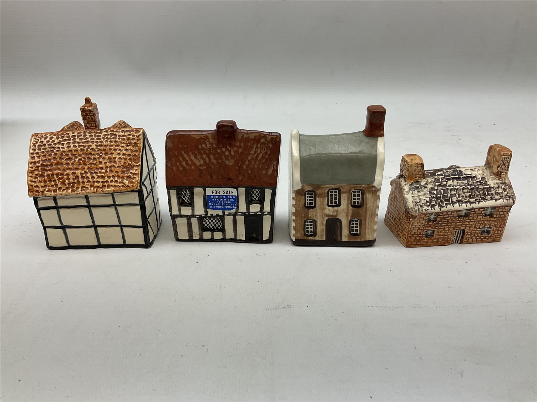 Twenty studio pottery figures of houses and cottages, comprising seventeen Mudlen End Studio Felsham Suffolk examples and two John Putman's Heritage Houses examples