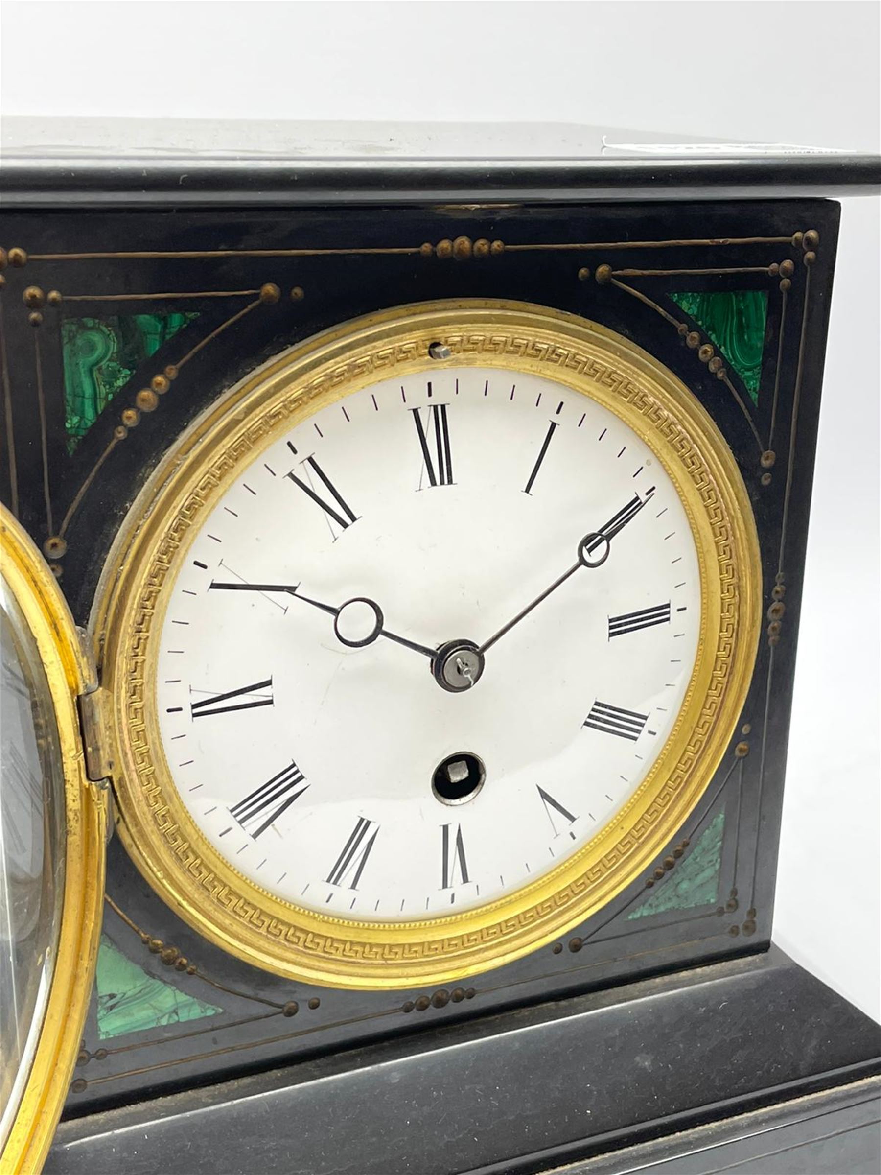 Victorian black slate mantel clock timepiece, the case with engraved and gilt decoration and inlaid with malachite, circular enamel Roman dial, single train driven movement