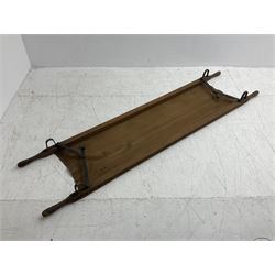 WW1 British casualty stretcher with iron mounted pitch pine sides and canvas base; stamped 'HL1917' and L7 with broad arrow in a triangle L236cm ( reputedly recovered from a barn at Bapaume on The Somme)