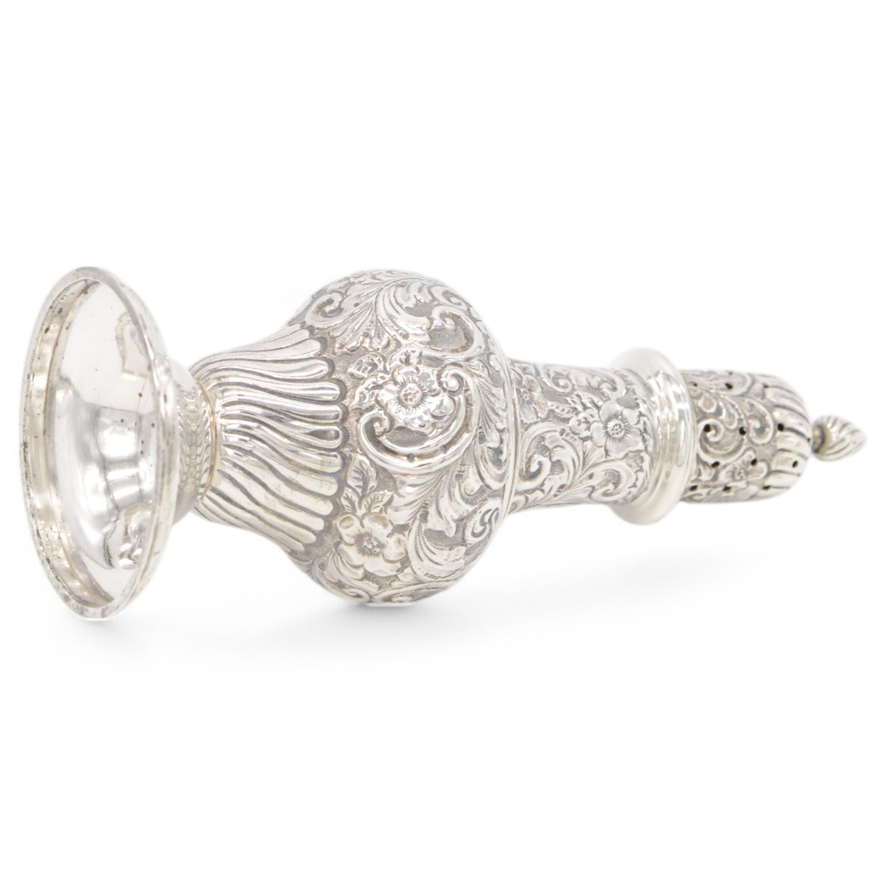 Edwardian silver sugar caster, of typical waisted form profusely embossed with floral and foliate decoration, the removable pierced cover with fluted finial, upon a circular stepped foot, hallmarked William Aitken, Birmingham 1901, H23cm