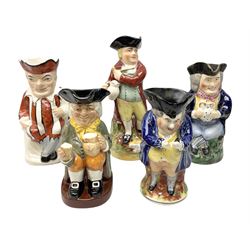 19th century and later Toby jugs comprising, Staffordshire 'Hearty Good Fellow', one jug modeled as Punch, one in the form of Tony with a jug of ale, Royal Doulton 'Happy John' and one of a man standing (5)