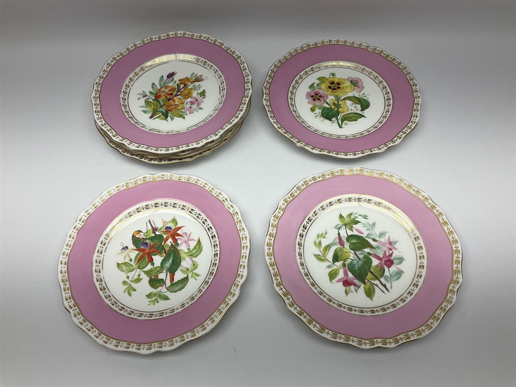 Victorian Copeland, Botanical dessert service, decorated with floral sprigs to the centre with a pink and gilt border, comprising five comports and seven plates, largest comport H20cm, plate D22cm