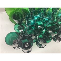 19th century and later green glass drinking glasses, to include several sets, including examples with knopped stems, together with green jug and seven plates