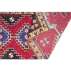 Turkish crimson ground rug, the field decorated with four hooked lozenges, trailing border with stylised flower heads 