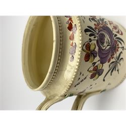 18th century creamware teapot, probably Leeds, with reeded entwined handle and floral finial to the cover, the body with hand painted polychrome decoration of figure to one side, and floral spray to the other, collectors paper label beneath inscribed Leeds Pottery, H11.5cm