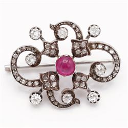 19th century French 18ct white gold ruby and diamond brooch by Eugène Fontenay, centrally set with a single cabochon cut ruby of approx 1.85 carat, the foliate scroll border set with eight old cut diamonds of approx 1.45 carat and rose cut diamonds, stamped with makers mark EF, eagles head and numbered 23960
