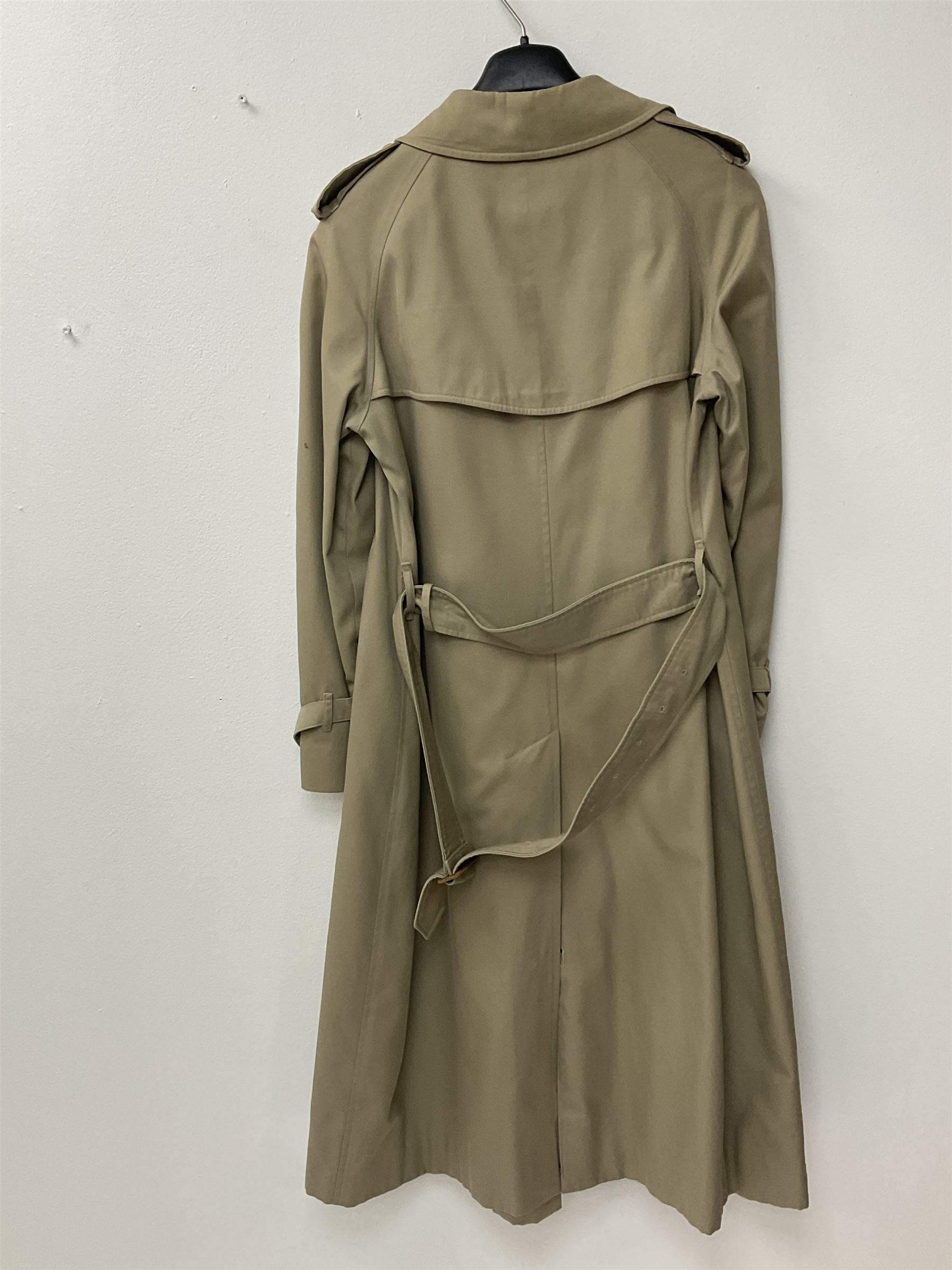 A ladies Burberry trench coat, with waist belt and check lining, no size label, measures approximately arm pit to arm pit L51cm, H117cm