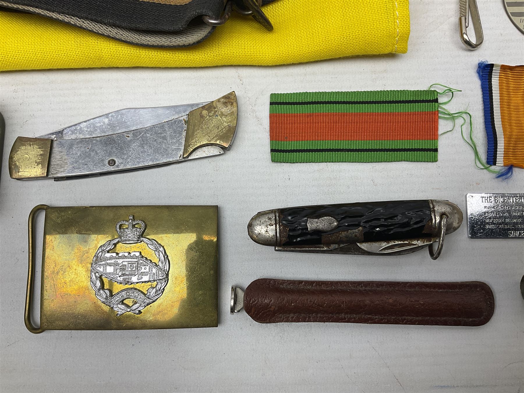 Miscellaneous militaria including two Royal Artillery and one Royal Horse Artillery stable belts; Northamptonshire Regiment trench art brass shell case lighter; unused Matchless Fire-Set; pocket knives and multi-tool; lanyards; oak shield with York & Lancaster crest etc