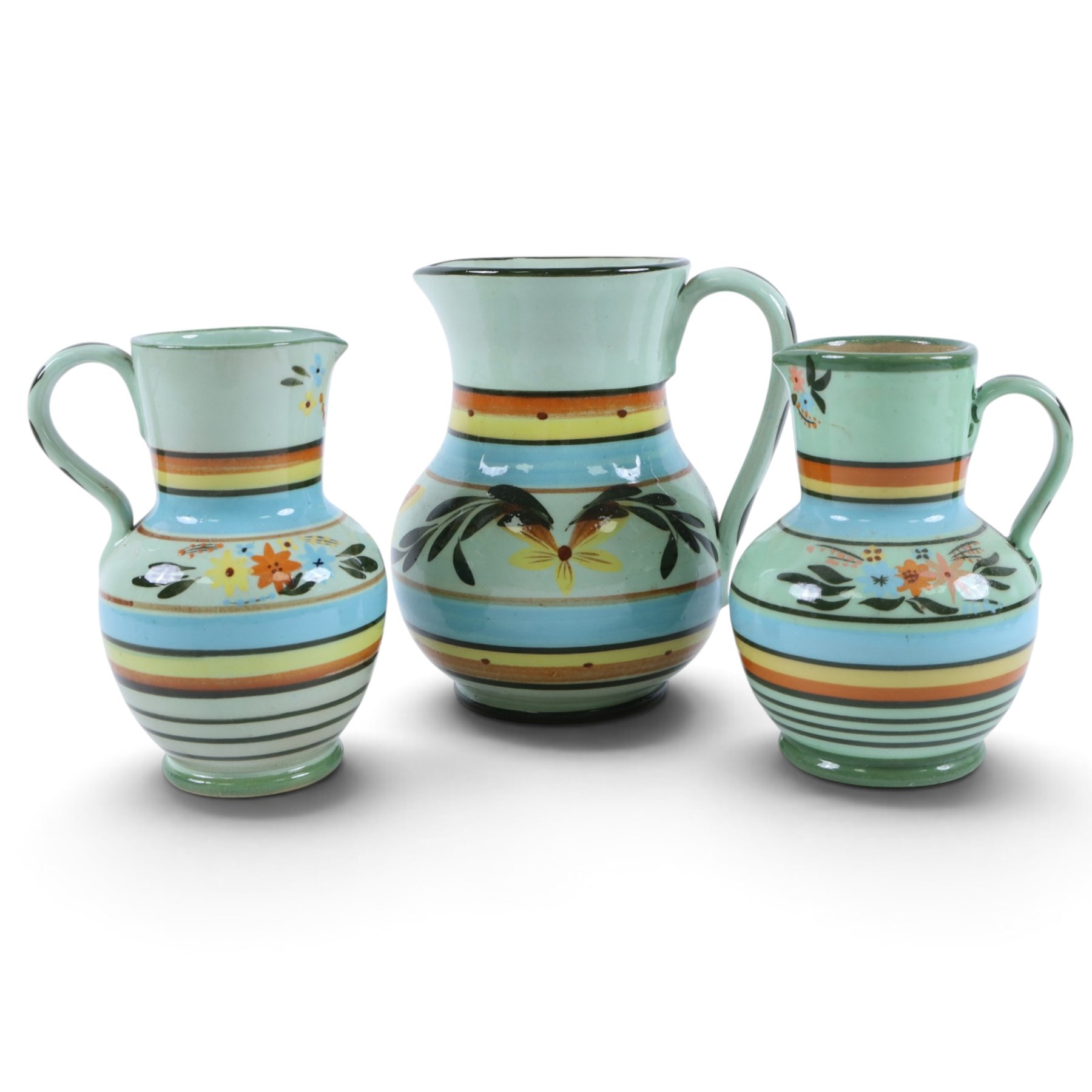 Hartrox Stoneware, comprising five jugs and two bowls, all with green, blue, yellow and oragne floral and abrstact decoration, with printed marks beneath, tallest H26cm