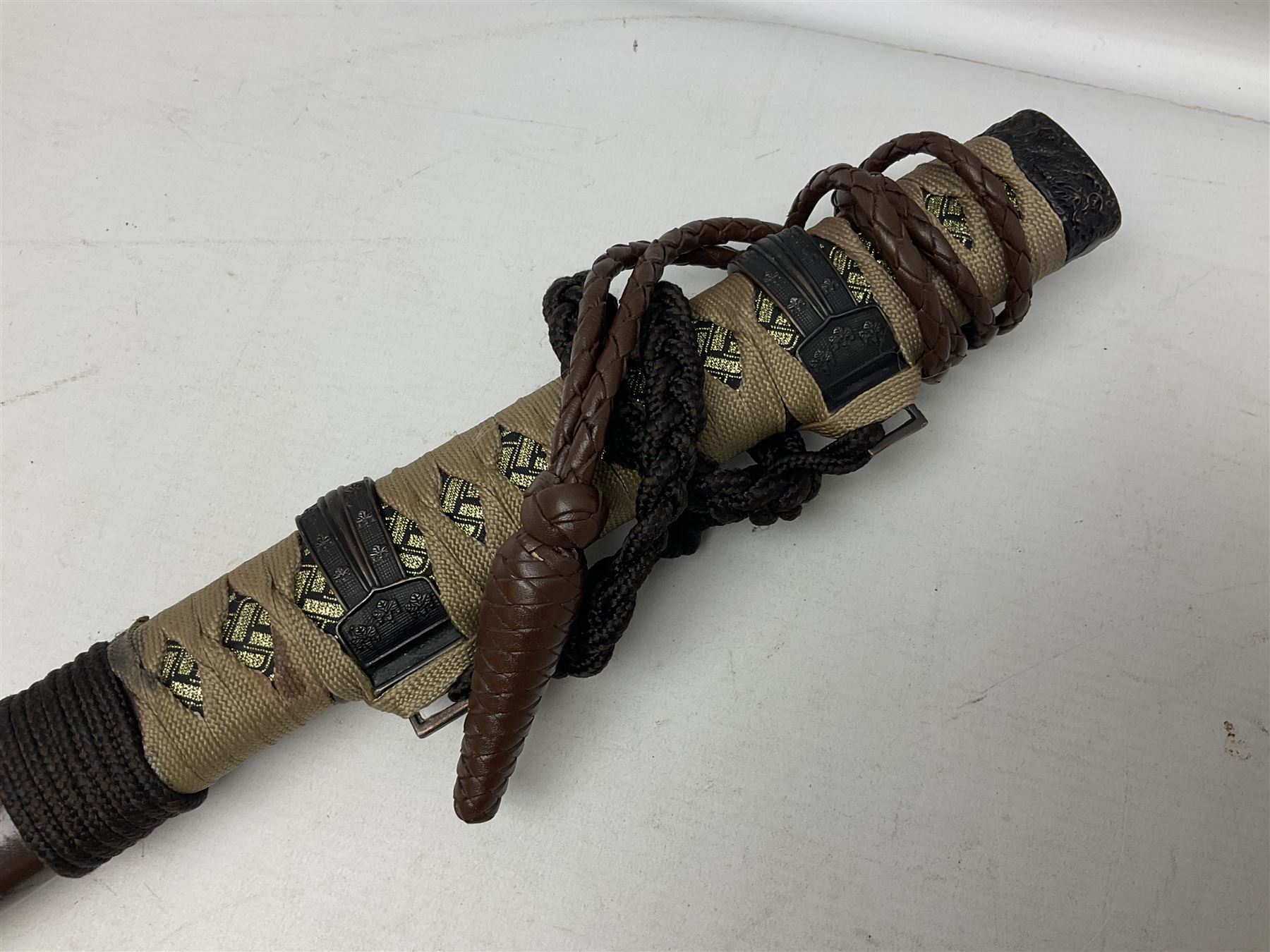 Reproduction Scottish officers basket hilt broad sword, the brass basket pierced with heart-shaped motifs lined with red lining, together with a reproduction Japanese Katana sword, longest L110cm