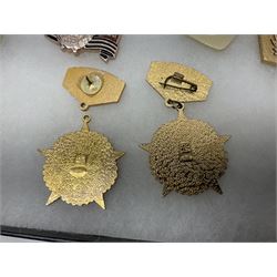 Nineteen Russian Soviet Tank Commemoration badges and medals, in small display case