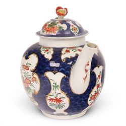 18th century Worcester teapot, circa 1763-70, of globular form, painted with shaped panels of chrysanthemums and banded hedges on a blue scale ground, cover with flower finial, mark beneath, H15cm