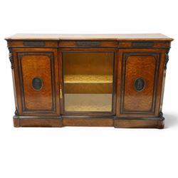 Lamb of Manchester (est. 1843) - Victorian Aesthetic Movement inlaid figured and burr walnut inverted-breakfront credenza, the shaped rectangular top with ebony banding and boxwood stringing, the frieze applied with bronze mounts decorated with foliate and scroll motifs, fitted with central glazed door flanked by panelled doors with central oval metal plaques depicting Classical Muses with lyre, the flanking canted uprights applied with caryatid maidens holding torches, acanthus terminal over skirted base