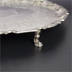 George II silver salver, of circular form with pie crust rim, with later floral and foliate decoration and presentation engraving to centre, upon three stepped feet, hallmarked William Peaston, London 1749, D30cm