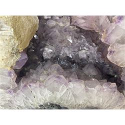 Amethyst crystal ‘cathedral’ geode, free standing with flat base and prepared outer surface, with well-defined crystals of various sizes within the cavern, H39, L32cm