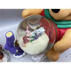 Six Disney Winnie the Pooh Christmas snow globes, comprising large Mr Christmas Holiday Snowfall, An Enchanted Christmas, It's A Small World Christmas 1994,  Tree Trimming, 1995 Christmas At Our House and Christmas Band Concert, together with Mr Christmas Holiday Go Round, all with boxes (7)