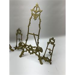 Collection of ornate brass easel picture stands, largest example H51cm