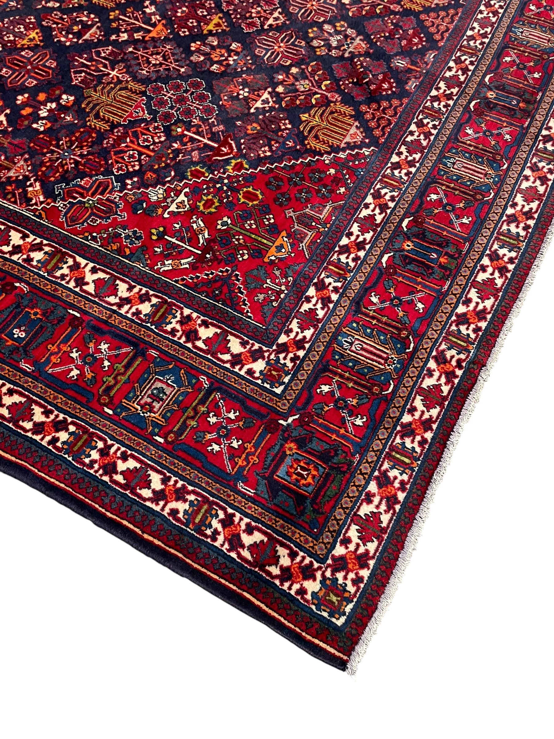 Persian Meimeh indigo ground rug, the central medallion within a field of small floral lozenge motifs, the guarded border with repeating pattern