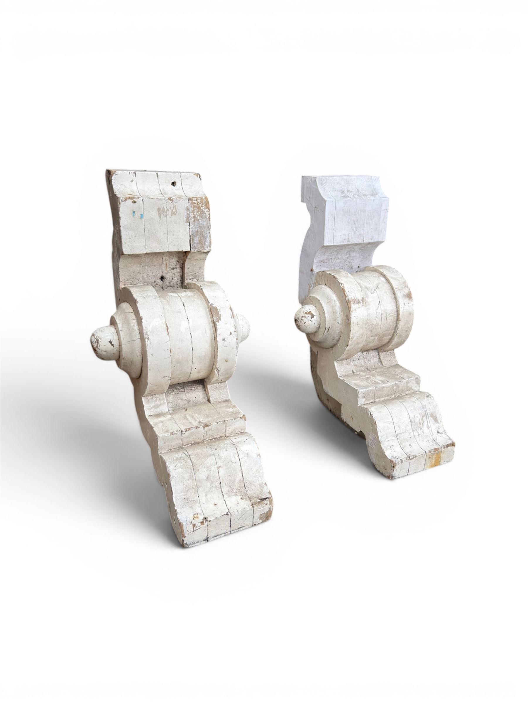 Pair of 19th century stripped pine columns  with carved capitols; an a pair of painted scroll architectural capitols (4)
