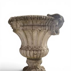Pair of Neoclassical design cast stone garden urns, each of campana form with fluted body and gadrooned underbelly, decorated with faun/satyr opposing masks and ropetwist handles, with floral and mask design to the socles, raised on square bases, finished in weathered white patina