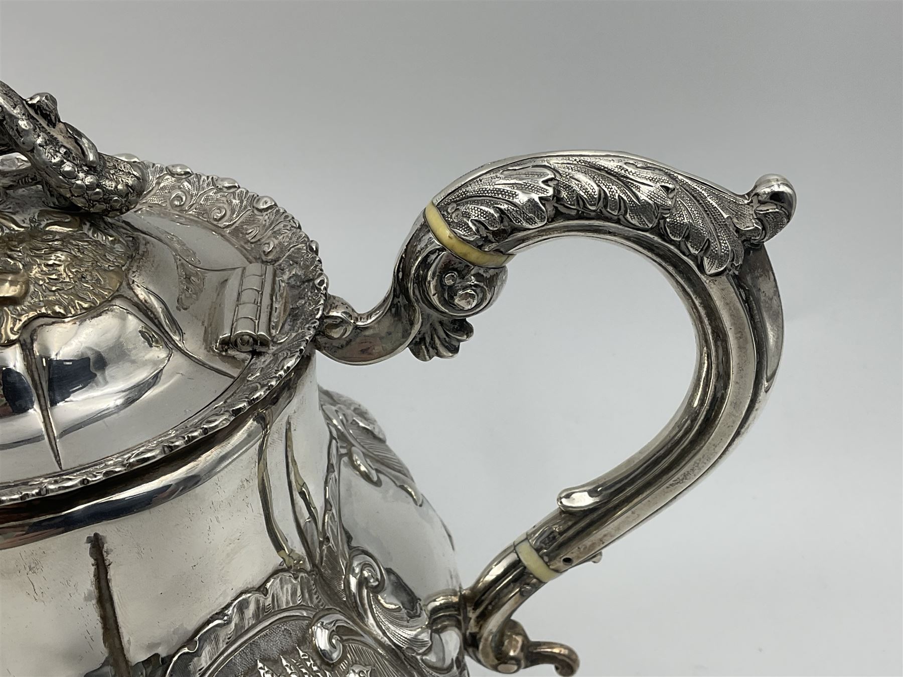 Victorian silver three piece tea service, comprising teapot, twin handled open sucrier, and milk jug, each of bellied form with acanthus capped scroll handles, the sides embossed with alternating scroll edged vacant panels and panels containing a pair of birds, upon four palmette feet, the teapot with ivory insulators to handle, and bird finial to the hinged domed cover, hallmarked William Hunter & Son, London 1861, teapot H19cm, including handles sucrier H13.5cm, including handle milk jug H12cm

This item has been registered for sale under Section 10 of the APHA Ivory Act