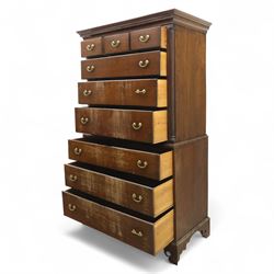 Mid 18th century oak tallboy chest, the projecting cavetto-moulded cornice over two short and three long drawers to the upper section, the lower section with three further graduated long drawers, each drawer with oak linings and fitted with later brass swan-neck handles, flanked by stop-fluted quarter columns, all raised on shaped bracket feet