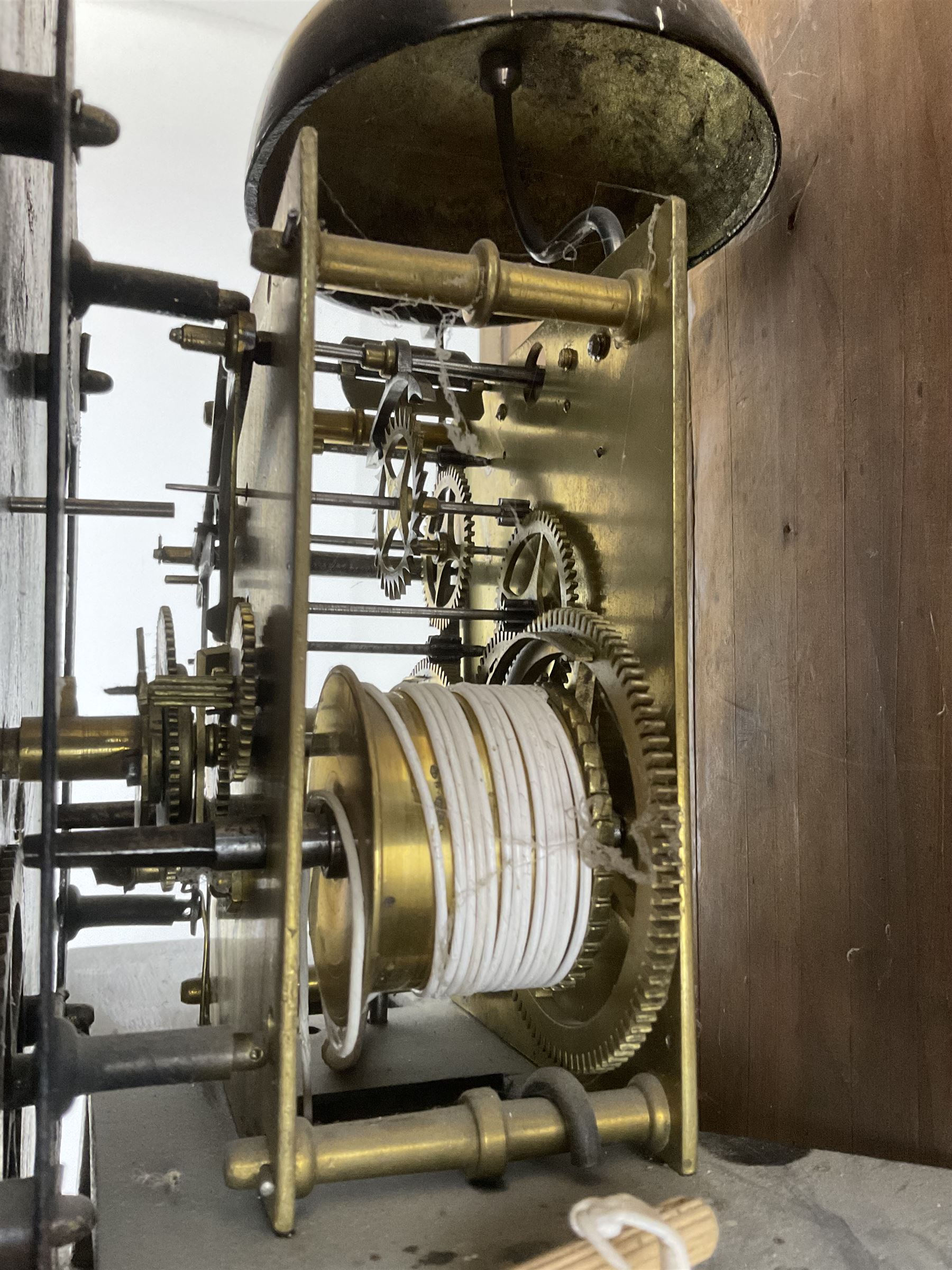 Charles Fletcher of Barnsley - Oak and Mahogany 8-day longcase clock, c 1830, with a swans neck pediment, silk backed open fret work beneath and a break arch hood door, flanked by reeded pilasters with wooden capitals, trunk with reeded quarter columns and a break arch topped door, plinth with inlaid banding on a shaped base, painted dial with Arabic numerals, seconds and date dials, stamped brass hands and painted depictions of the four seasons to the spandrels, dial pinned via a false plate to a rack striking movement with a recoil anchor escapement, striking the hours on a cast bell. With weights and pendulum.