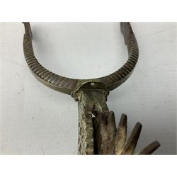 Pair of late 19th century South American iron spurs, engraved silver mounts, with sunburst rowls