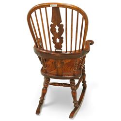 Broadarm Windsor rocking chair, arched crest rail enclosing turned spindle back with pierced splat, wide shaped arms with turned supports, solid elm seat, raised on turned legs united by double stretchers, on swept rockers
