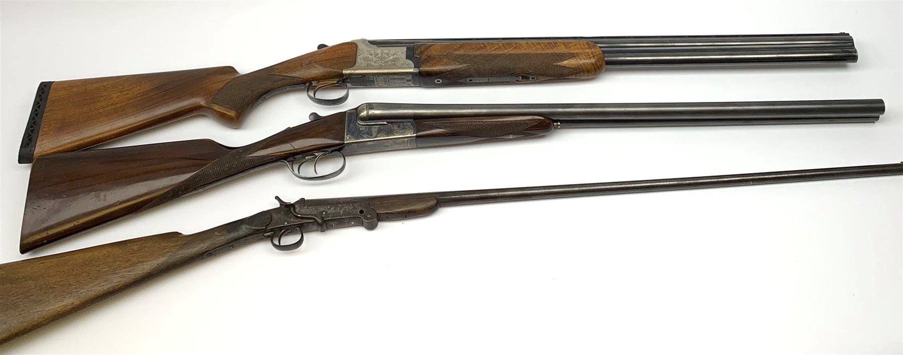Miroku 12-bore box lock ejector over-and-under double barrel shotgun with walnut stock and 66cm barrels, No.2277306, L112cm overall; Sabel 12-bore box lock non-ejector side-by-side double barrel shotgun with 66cm barrels, No.62546, L108cm overall; Lambert Dumoulin folding .410 single barrel shotgun; and leather 12-bore cartridge belt (4) RFD ONLY