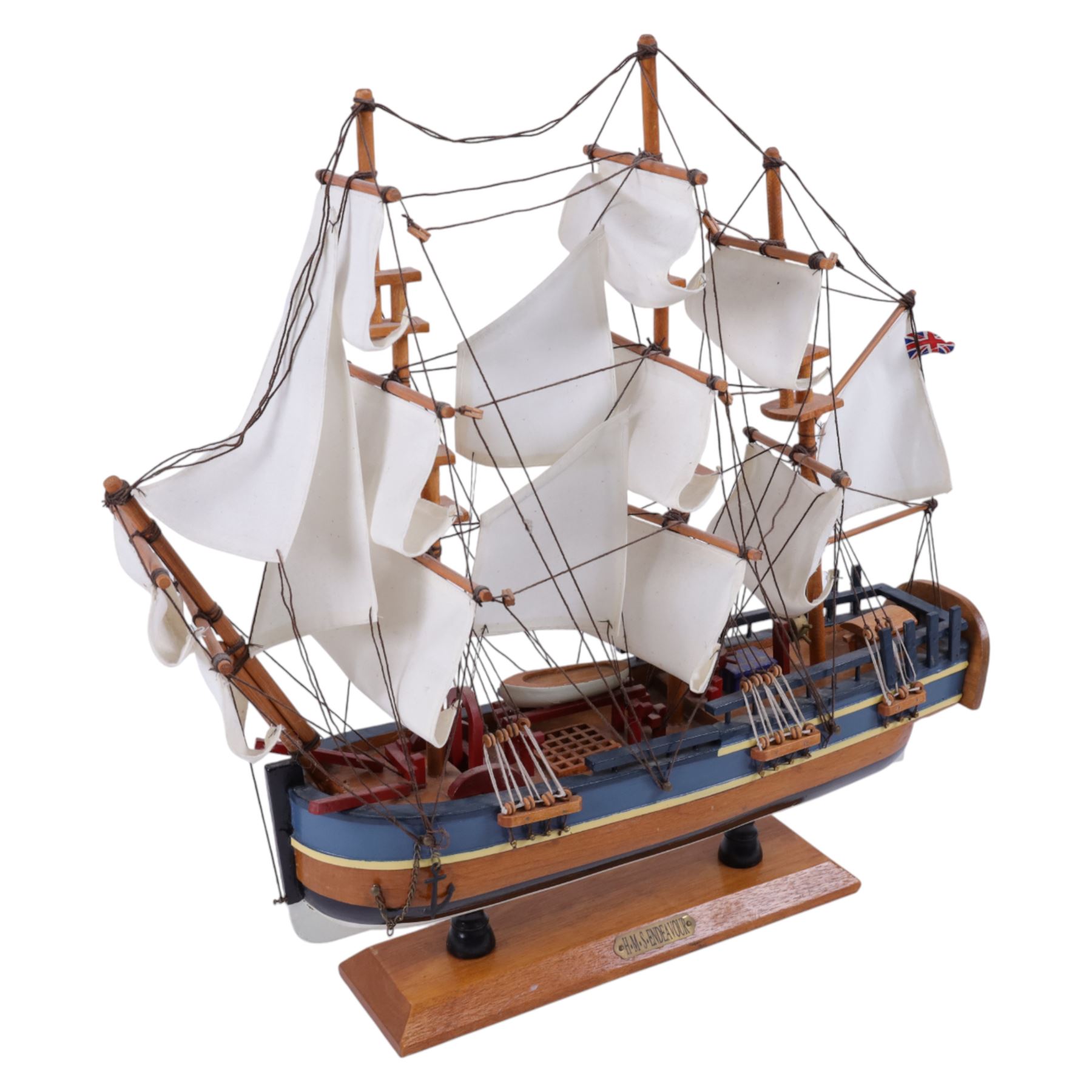 Three wooden model ships, comprising a single mast Schooner style pond yacht, a kit-built Viking longship and a model of HMS Endeavor, Schooner H117cm