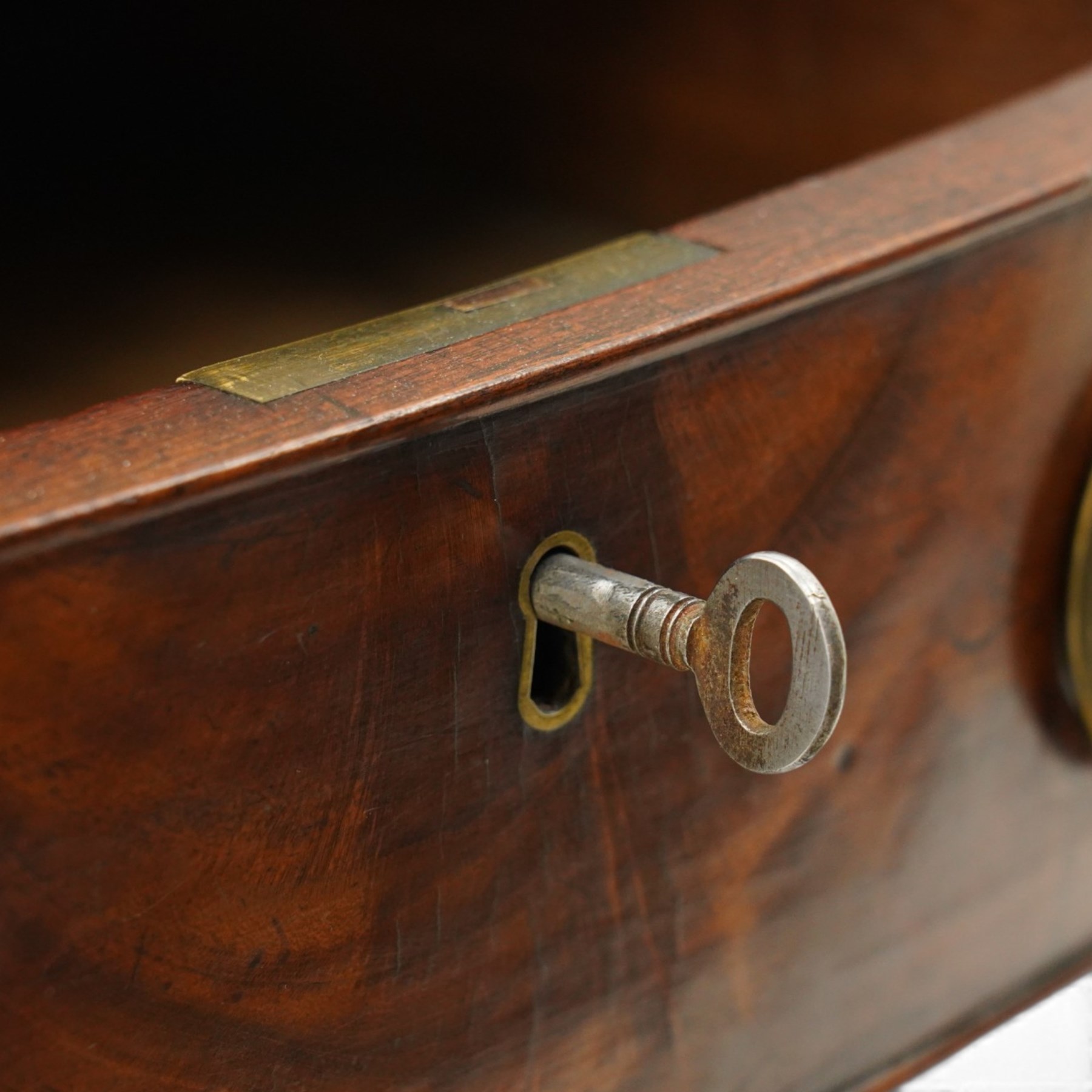 George III inlaid mahogany serpentine sideboard, the shaped top with crossbanding and satinwood stringing, fitted with central bow-front cock-beaded frieze drawer over a shaped apron inlaid with paterae, shell motifs and scrolling foliage, flanked by a deep right-hand drawer and two drawers to the left, raised on square tapering supports with spade feet