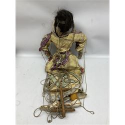 Large string puppet, probably Thai or Burmese, modelled as a woman in traditional costume embellished with sequins, the painted head with articulated mouth, the wood body and hands jointed, L70cm