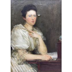 Theodore Blake Wirgman (British 1848-1925): Portrait of a Lady in her Study, oil on canvas signed 35cm x 24cm 